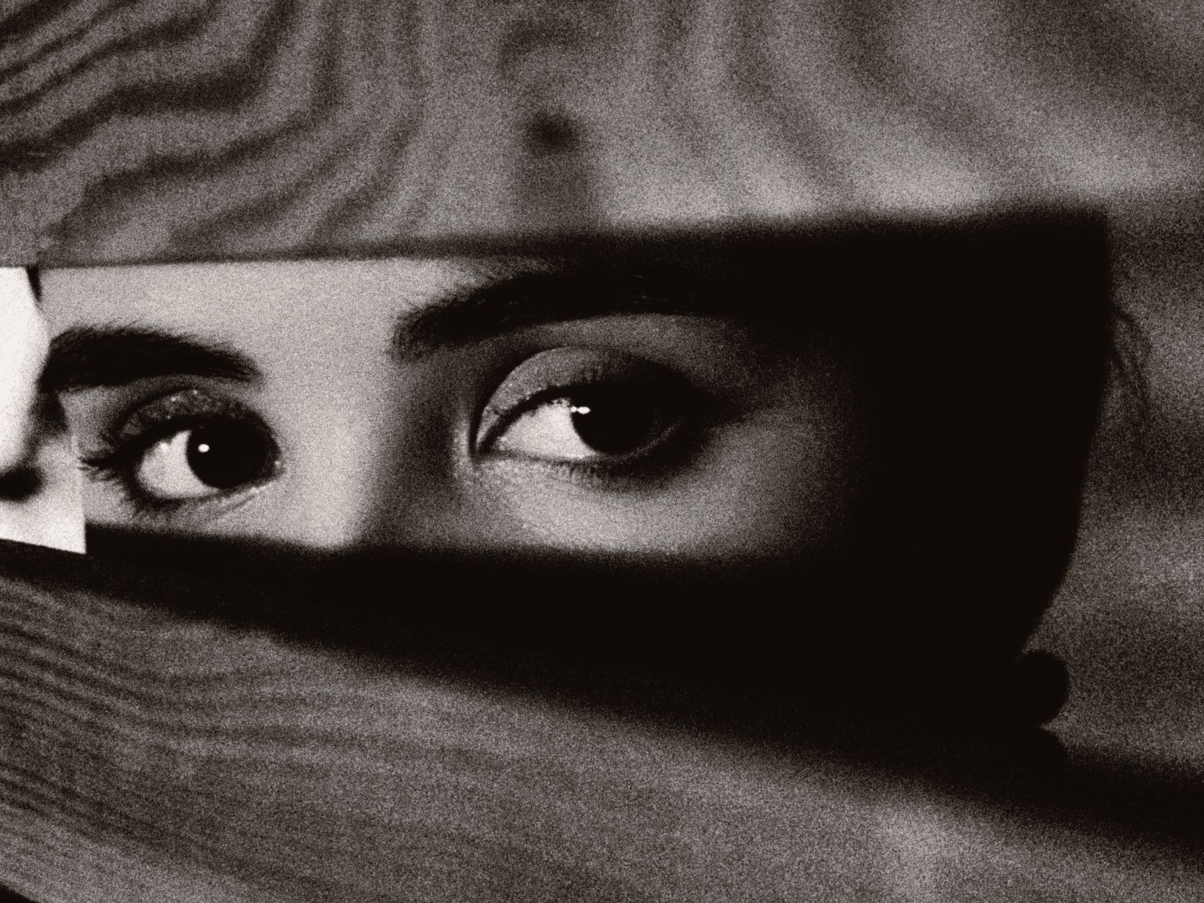 woman eyes in gap between planks